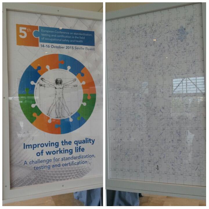 Big vertical jigsaw puzzle showing the conference logo on the front and participants' signatures on the rear
