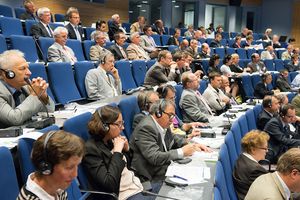 Conference delegates listening to a presentation in the plenary hall