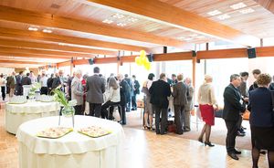 People talking in small groups at a dinner reception