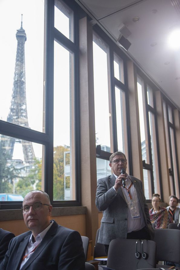 A conference participant asks a question during the Q+A session