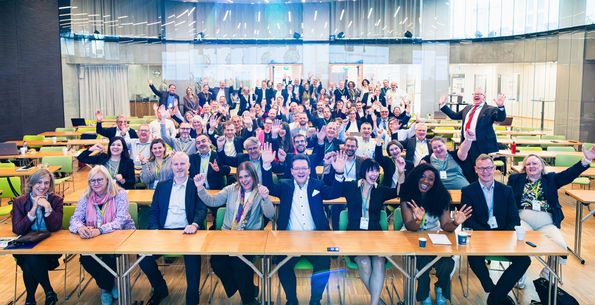 Group picture of cheering conference participants