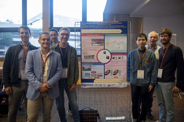 Presenters standing next to their poster in the exhibition