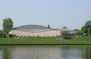 Outside view of the rounded shape of the Manggha Museum by the river