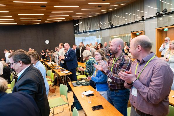 Participants applaud after a presentation