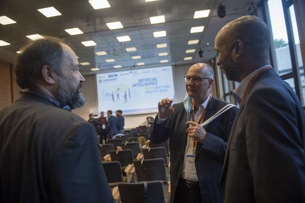 Group of people talking in the conference hall before the start of the conference 